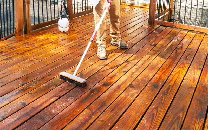 man-applying-stain-on-deck